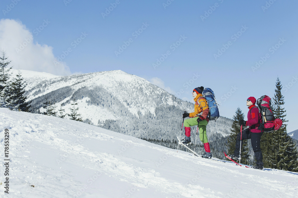 Winter Trekking in the mountains. Two men make an ascent to the top. Winter Trekking in the mountains. Two men make an ascent to the top.