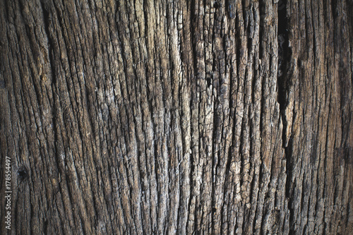 Abstract background surface is uneven and rutted, rough wood of old.