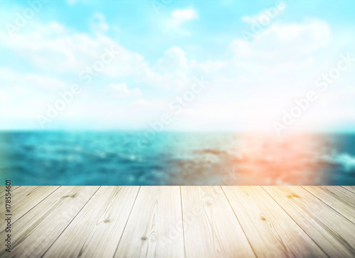 Wood table top on blur sea background. Summer  nature concepts. For montage product display or design key visual layout.