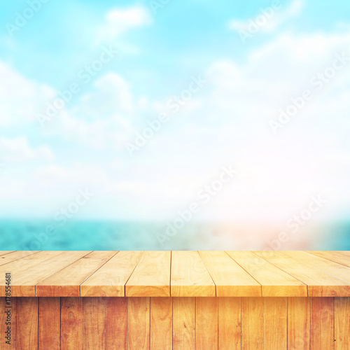 Wood table top on blur sea background. Summer, nature concepts. For montage product display or design key visual layout.