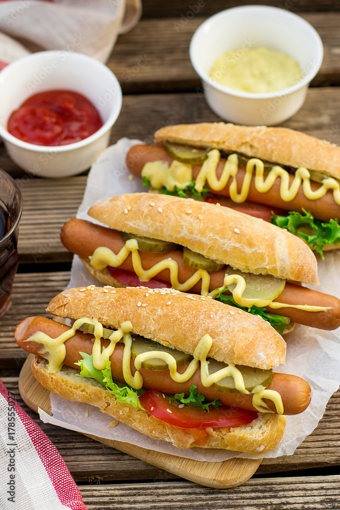 Fototapeta premium Hot dog in a bun with mustard and vegetables