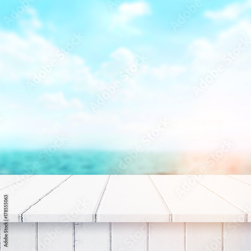 Wood table top on blur sea background. Summer, nature concepts. For montage product display or design key visual layout. © vander