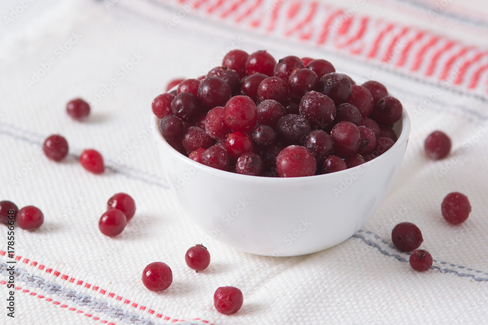 frozen cranberry berries in a plate on a white tablecloth frozen cranberry berries in a plate on a white tablecloth