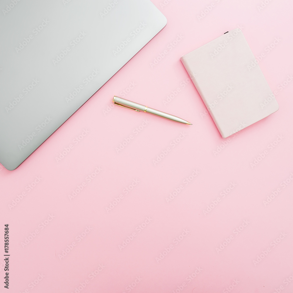Home office desk workspace with laptop, notebook and pen on pink background. Top view. Flat lay lifestyle concept. Home office desk workspace with laptop, notebook and pen on pink background. Top view. Flat lay lifestyle concept.