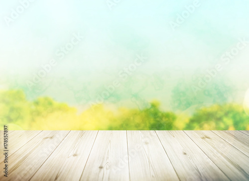 Wood table top on blur tree background. Summer  nature concepts. For montage product display or design key visual layout.