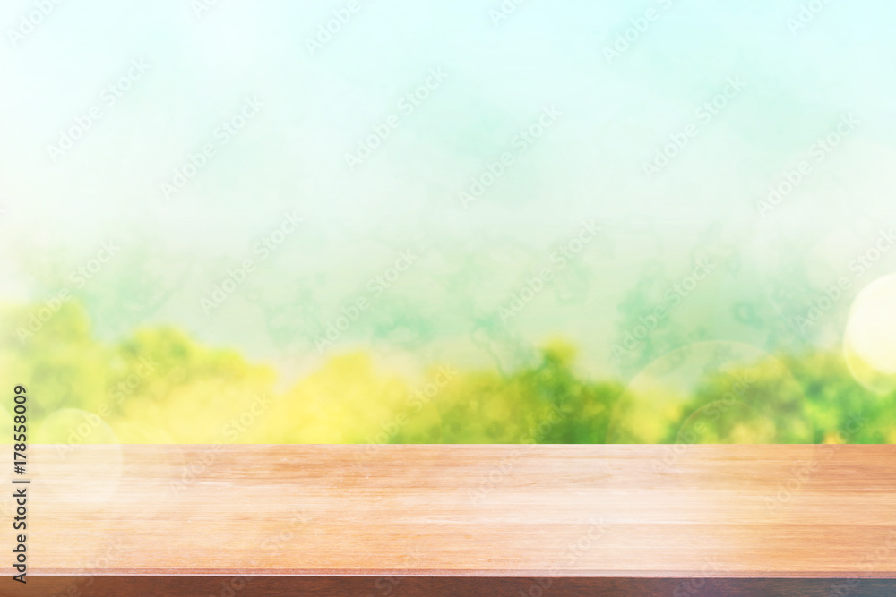 Wood table top on blur tree background. Summer, nature concepts. For montage product display or design key visual layout.