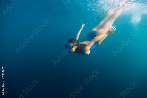 Young woman swimming in ocean, snorkeling underwater view