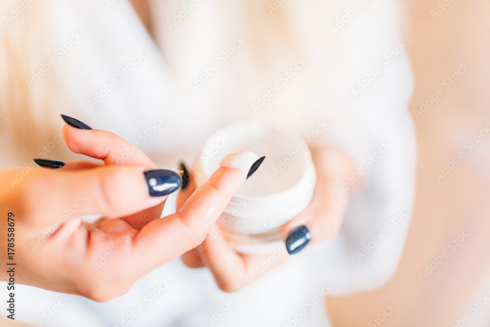Smiling female person in bathrobe, skincare Smiling female person in bathrobe, skincare