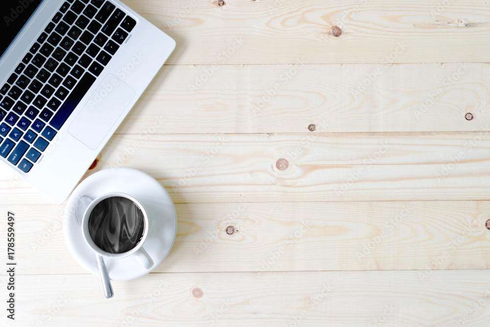 Keyboard of an open notebook, cup of coffee Keyboard of an open notebook, cup of coffee