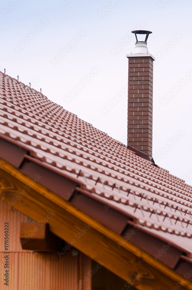 new house with orange brick wall, roof and chimney. House building worker concept.