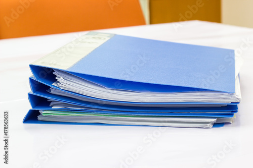 blue files folder. retention of contracts and paper. on the table in the meeting room 