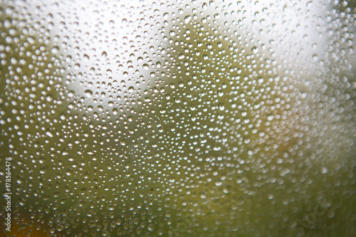 Water droplets on the window. Blurry background.