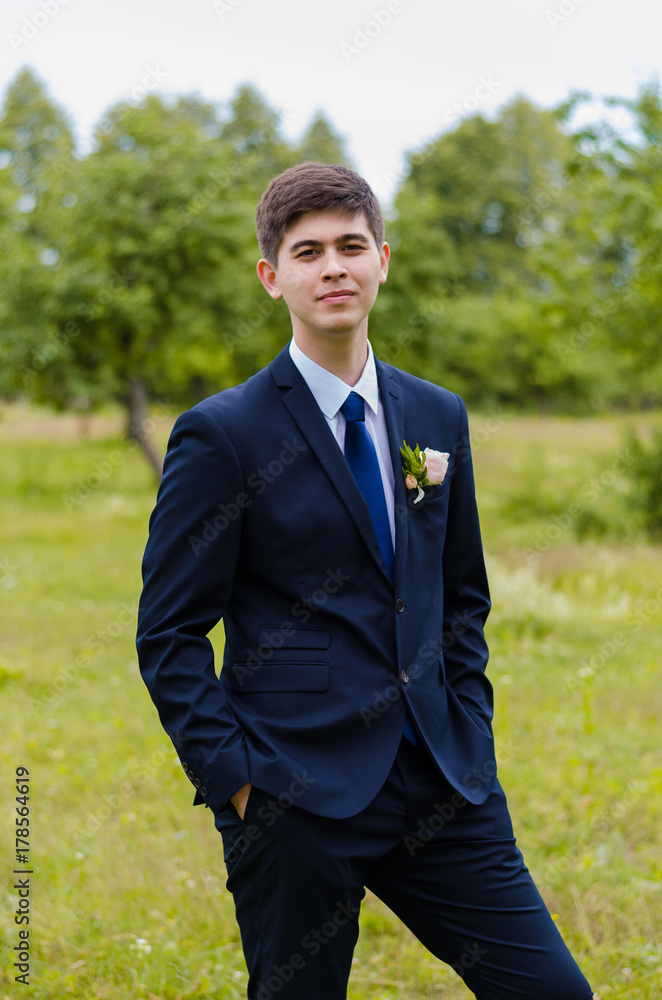 A beautiful married man in costume, posing for a photo shooting in an belarusian village. Green background A beautiful married man in costume, posing for a photo shooting in an belarusian village. Green background