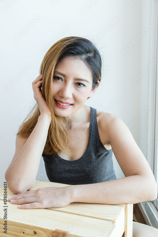 Young beautiful asian woman wear white shirt morning wakeup pose action with white curtain background Young beautiful asian woman wear white shirt morning wakeup pose action with white curtain background