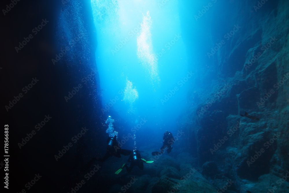Underwater caves in the ocean with scuba divers