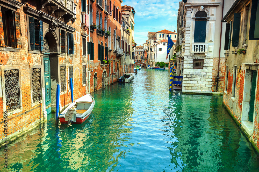 Spectacular narrow canal with boats in Venice, Italy, Europe