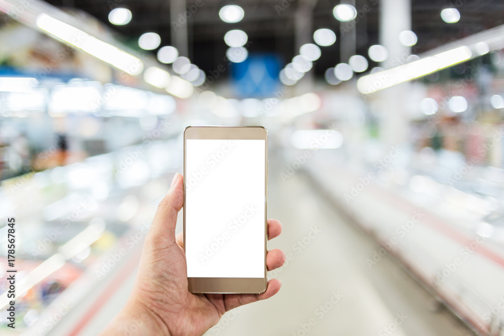 hand use smartphone with blur background of supermarket hand use smartphone with blur background of supermarket