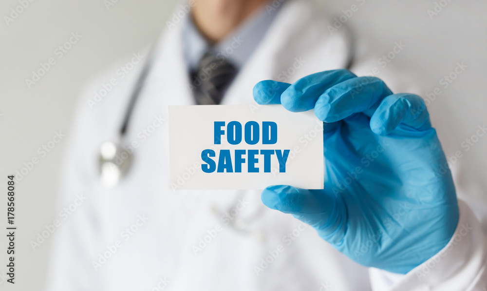 Doctor holding a card with text Food Safety, medical concept Doctor holding a card with text Food Safety, medical concept
