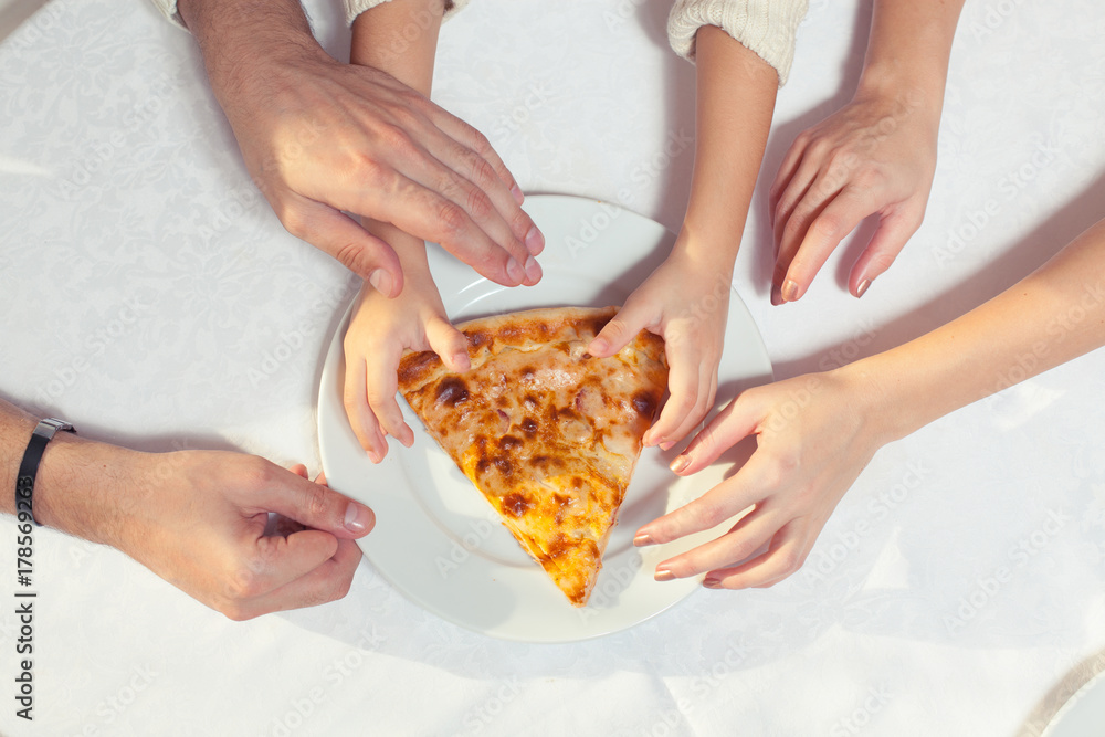 People Hands Grabbing Pizza from white plate