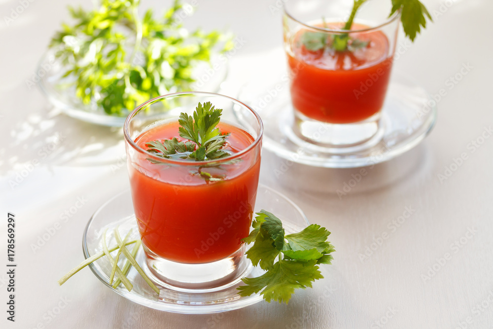 Natural tomato juice with parsley and celery greens two glasses Natural tomato juice with parsley and celery greens two glasses