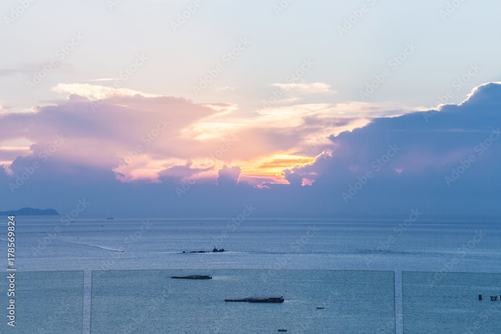 Beautiful view of Infinity Swimming Pool with sunset on the sea at twilight times.