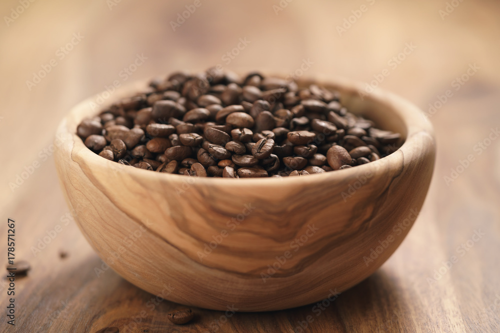 roasted coffee beans in wood bowl on table roasted coffee beans in wood bowl on table