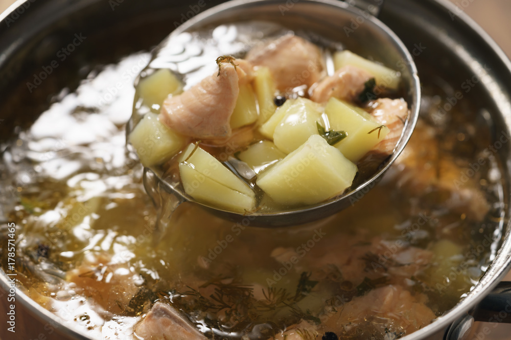 prepared hot trout soup with potatoes in pot