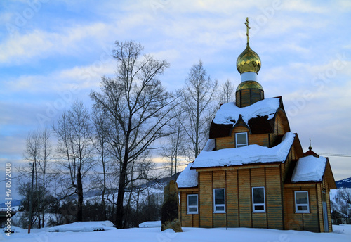 Old wooden church in snow