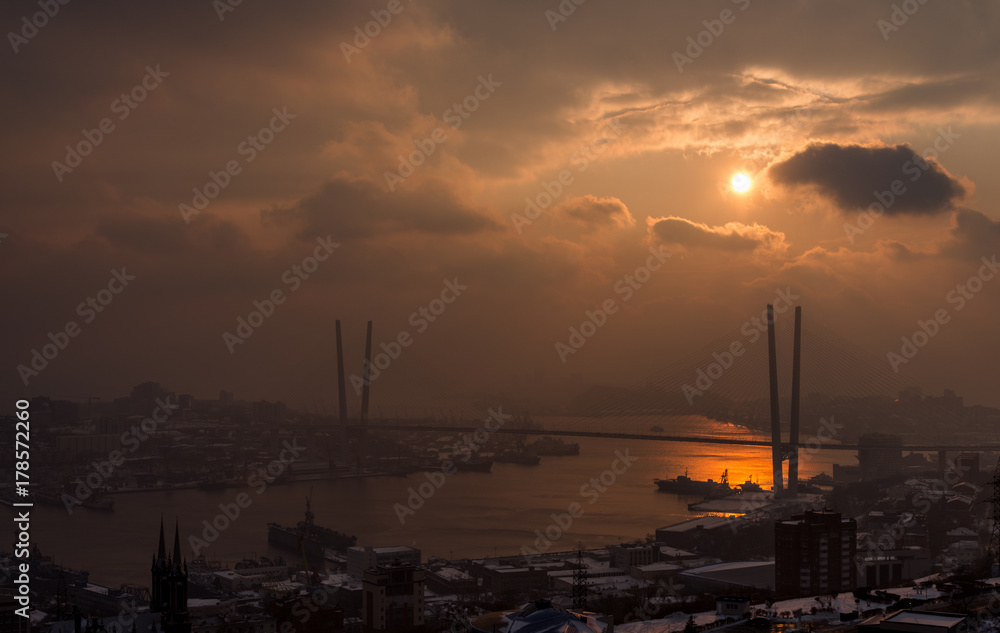 Vladivostok cityscape with dramatic sunset sky.