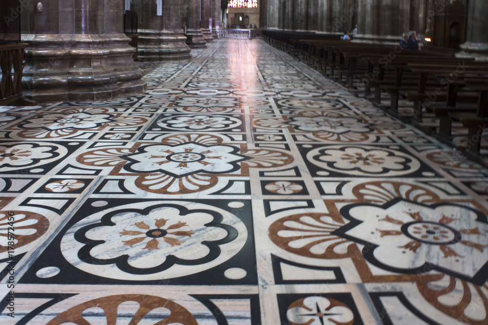 Inside Duomo cathedral in Milan, detail of the decorated floor in candoglia marble with flower pattern