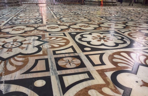 Inside Duomo cathedral in Milan, detail of the decorated floor in candoglia marble with flower pattern photo
