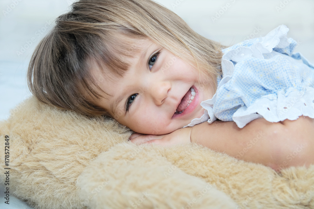 Little girl portrait happy smiling with Teddy bear hugging toy Little girl portrait happy smiling with Teddy bear hugging toy