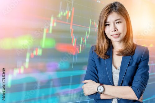 beautiful asian business woman with Candle stick graph chart of stock market investment trading