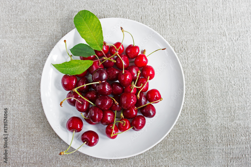 Sweet cherries on the white plate Sweet cherries on the white plate