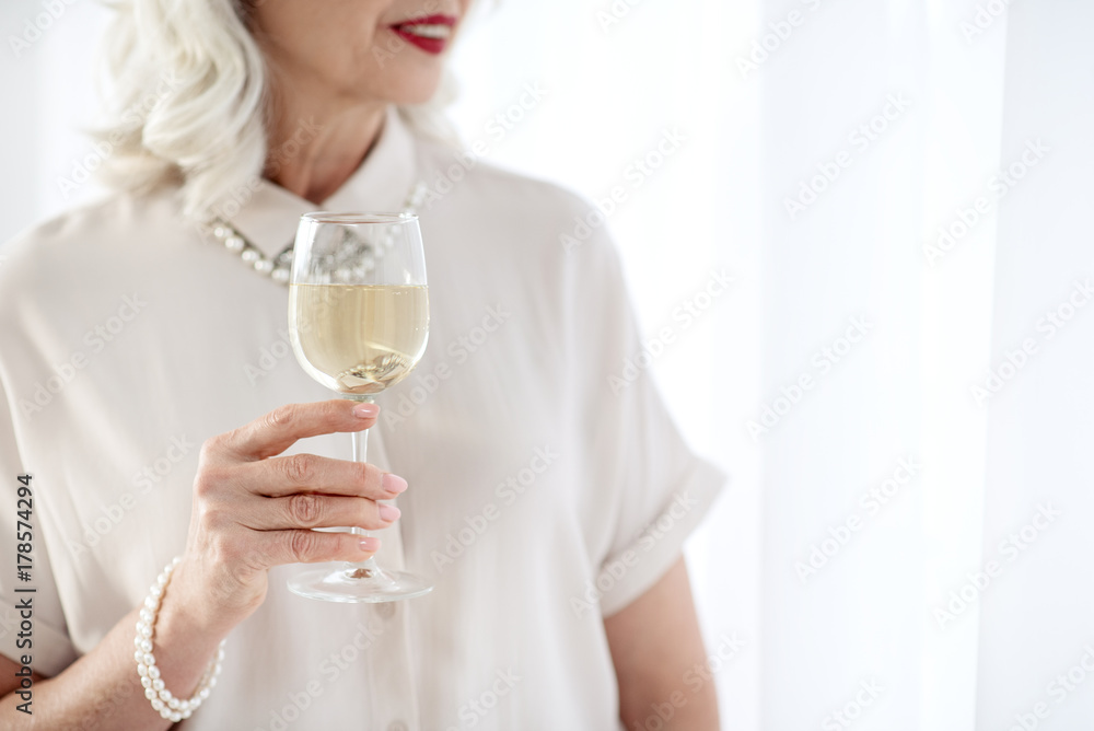 Happy senior elegant woman drinking champagne Happy senior elegant woman drinking champagne
