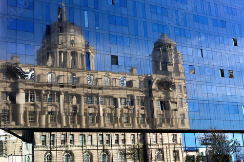 Reflection of a classic building in a modern glass wall
