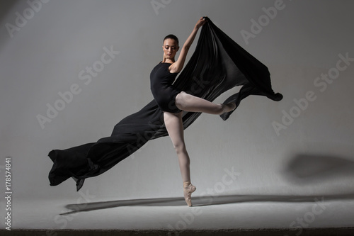 Graceful ballerina posing with black cloth