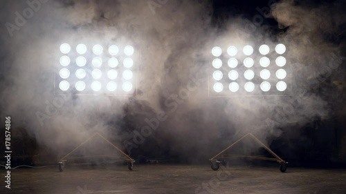a young woman of pleasant appearance dances in the training hall in the lighting of searchlights in the background. a professional dance girl performs the set number in the style of lacquering and