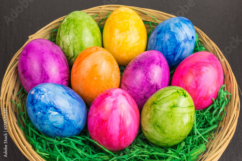 colorful painted easter eggs in a basket