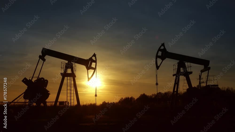 working oil pumps silhouette against sunset, 4k
working oil pumps silhouette against sunset, 4k