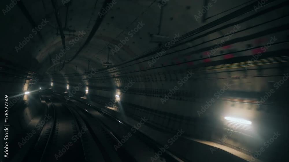 View of subway tunnel as seen from reverse of moving backward train. Fast underground train riding in tunnel of modern city.Long footage of underground train following its route View of subway tunnel as seen from reverse of moving backward train. Fast underground train riding in tunnel of modern city.Long footage of underground train following its route