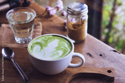 green tea hot drink latte white cup on wood table aroma relax time in coffee shop