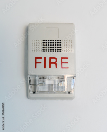 Fire alarm siren with flashing light strobe isolated on white