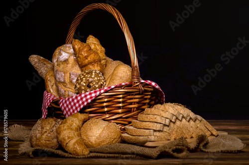 Set of Baked Bread with basket; Various fresh bread such as sesame bun, baguette, baked rolls, croissant, round bun and whole grain sliced bread