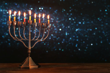 jewish holiday Hanukkah background with menorah (traditional candelabra) and burning candles