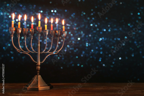 jewish holiday Hanukkah background with menorah (traditional candelabra) and burning candles
