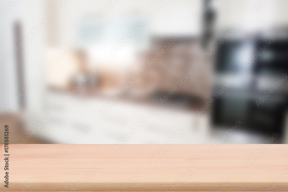 Wood table top with blur kitchen interior to promote your products Wood table top with blur kitchen interior to promote your products