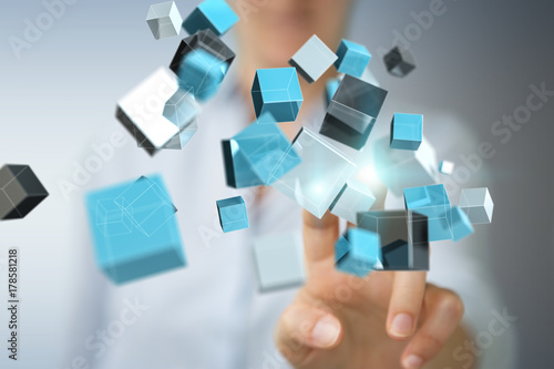 Businesswoman using floating blue shiny cube network 3D rendering