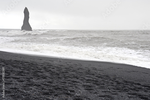 Vik  -  Reynisfjara Beach - basalt cliffs in a typical Icelandic landscape, a wild nature of rocks and shrubs, rivers and lakes. © RiCi