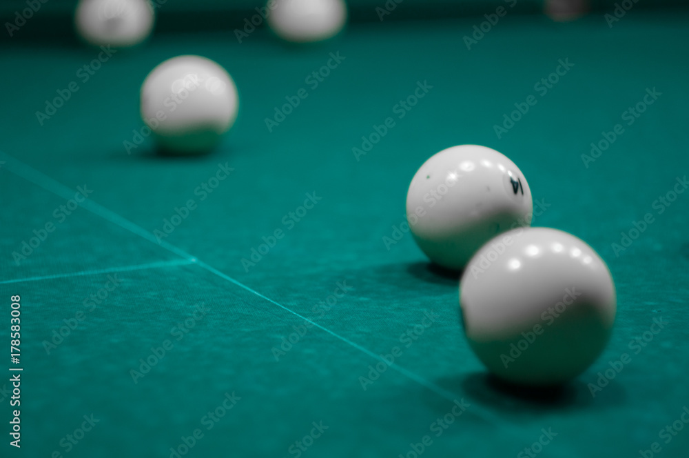billiard green table in hall with white balls with man hand billiard green table in hall with white balls with man hand